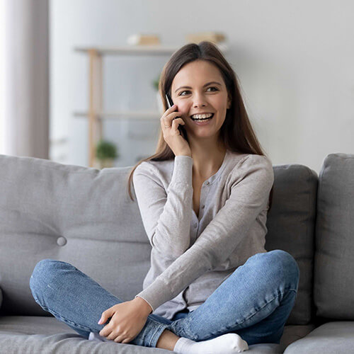 A professional woman confidently providing outstanding customer service over the phone at a BoxDrop franchise, leveraging the strong brand reputation and customer referrals.